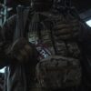 a person in military gear holding a pack of food